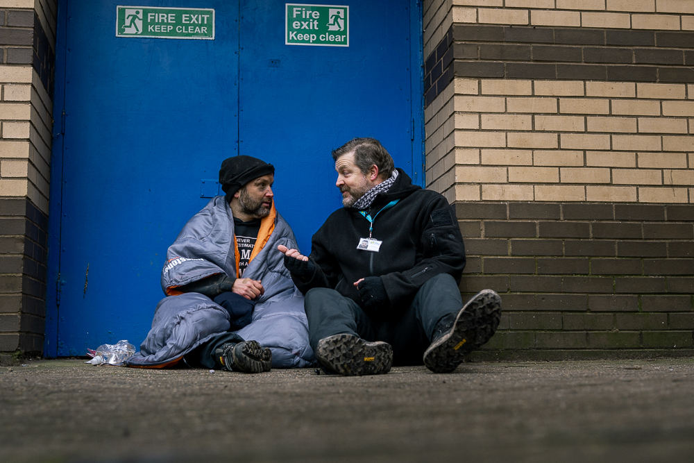 Stay team member talking to a homeless man